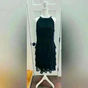 Evan Picone black sleeveless dress, pleated neckline, tier bottom, satin waist.